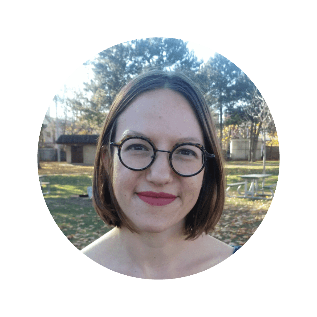 Melanie Wilmink, a white woman with short brown hair, smiles at the camera. She is wearing glasses.
