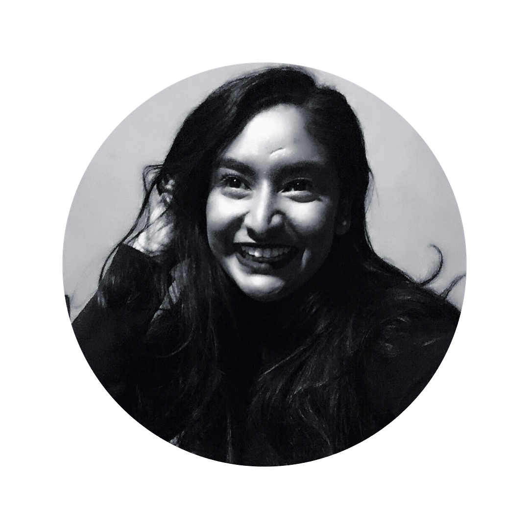 Senjuti Sarker smiles at the camera. The image is black and white. Senjuti is a woman with long hair and she is smiling at the camera.