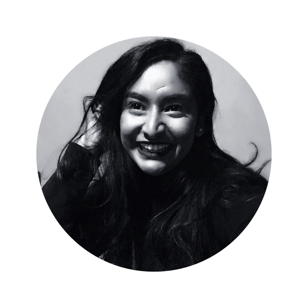 Senjuti Sarker smiles at the camera. The image is black and white. Senjuti is a woman with long hair and she is smiling at the camera.
