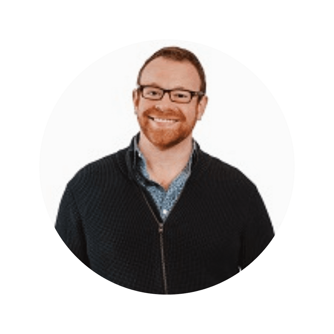 Image of Shawn Newman, a white man with closely cropped hair and a ginger beard. He is wearing glasses and smiling.